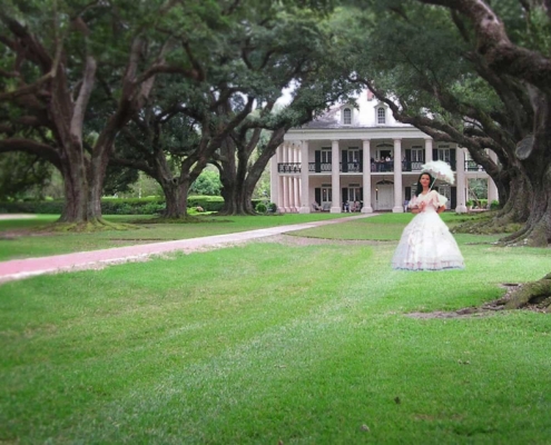 Oak Alley Plantation with woman in period dress