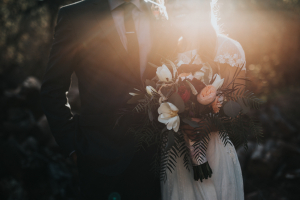 bride and groom holding a bouquet
