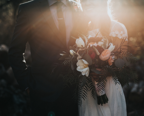 bride and groom holding a bouquet