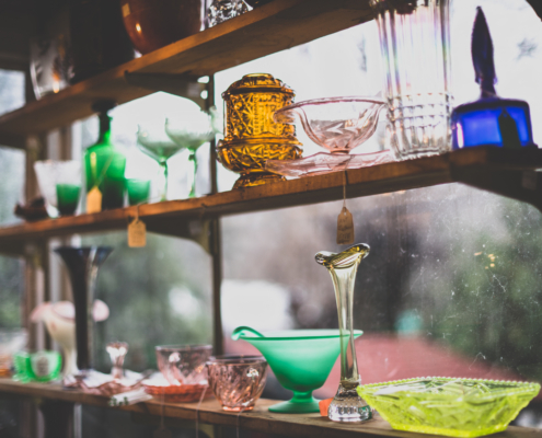 antiques on a shelf at an antique shop