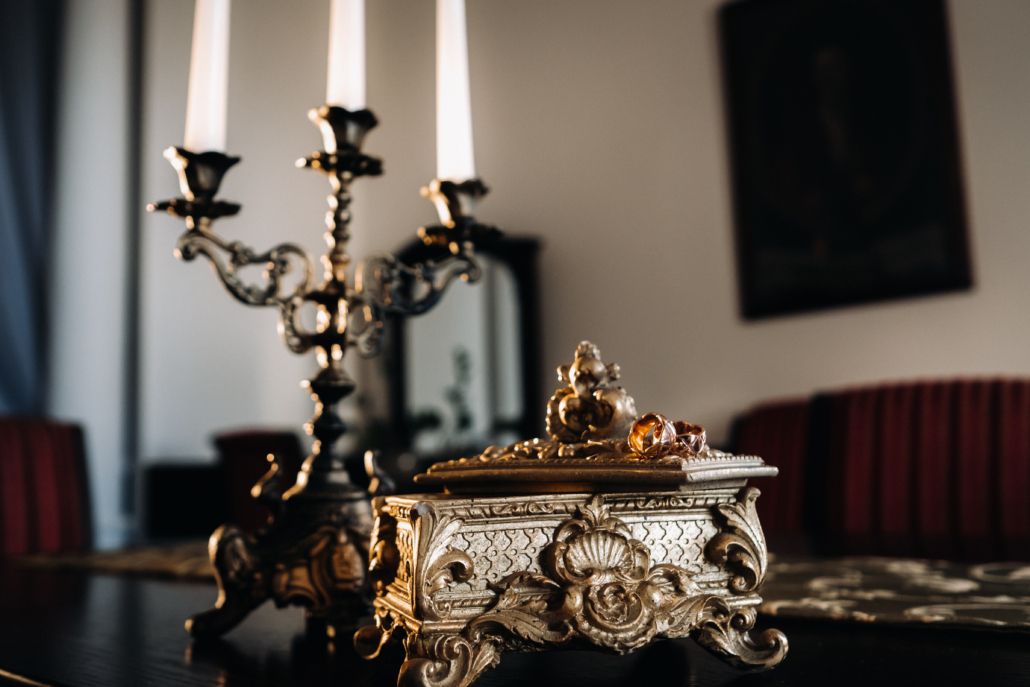 gold rings lie on an antique jewelry box