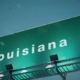 a green sign that says louisiana