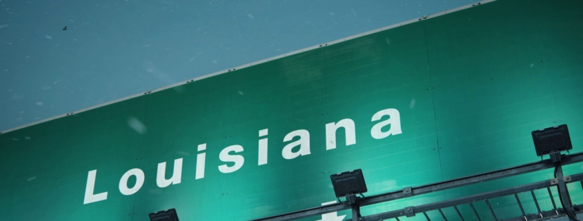 a green sign that says louisiana