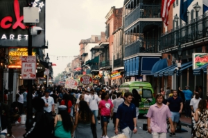 a large crowd of tourists walking down a busy bourbon street in new orleans